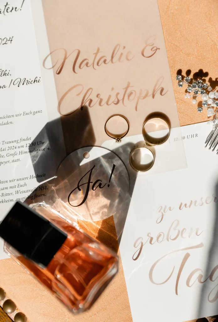 The rings are on the table next to the parfume, wedding day