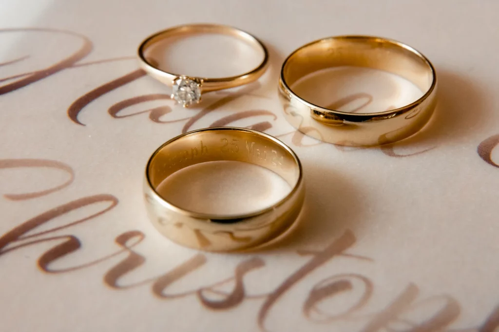 the rings are on the table, wedding photographer
