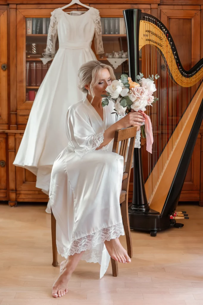 the bride sits with a bouquet against the background of the dress, brides morning