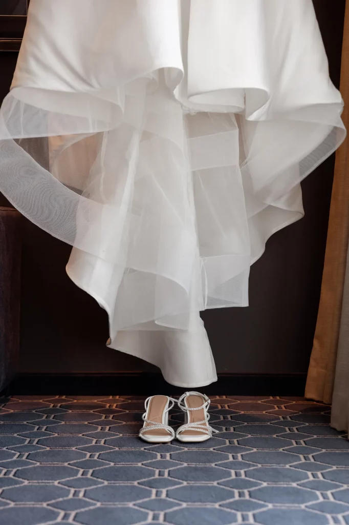 Brautkleid mit weißen Schuhen auf Teppichboden