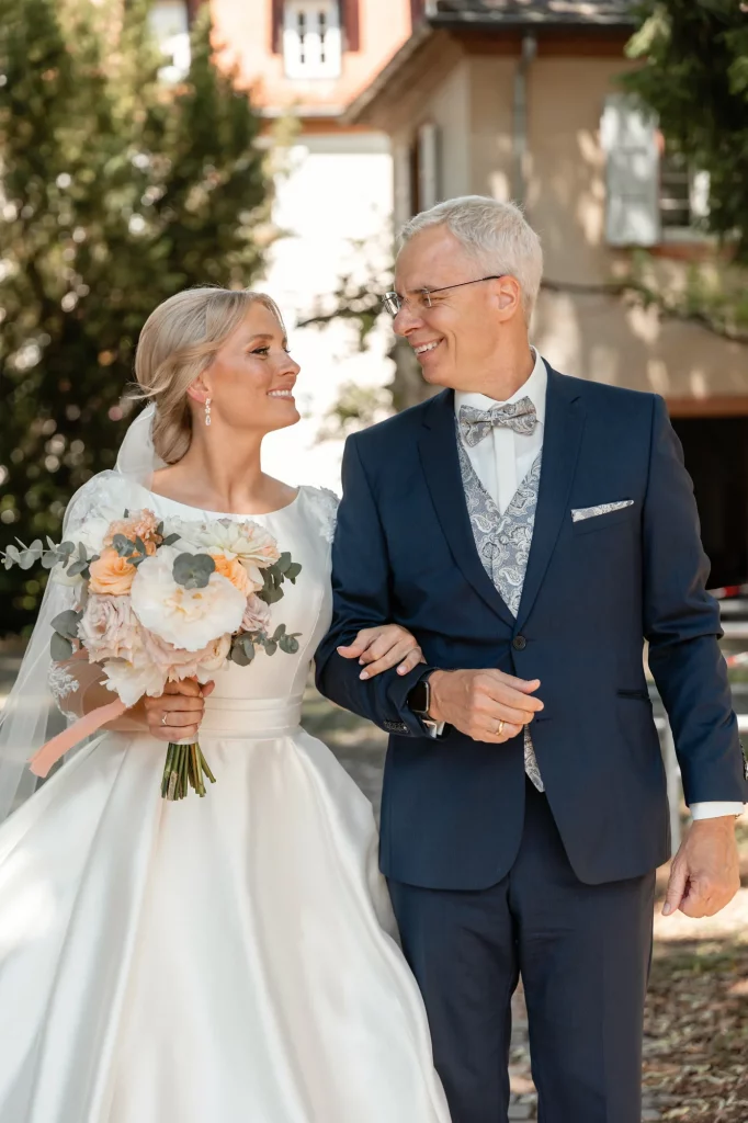 the bride and her father are walking to the church