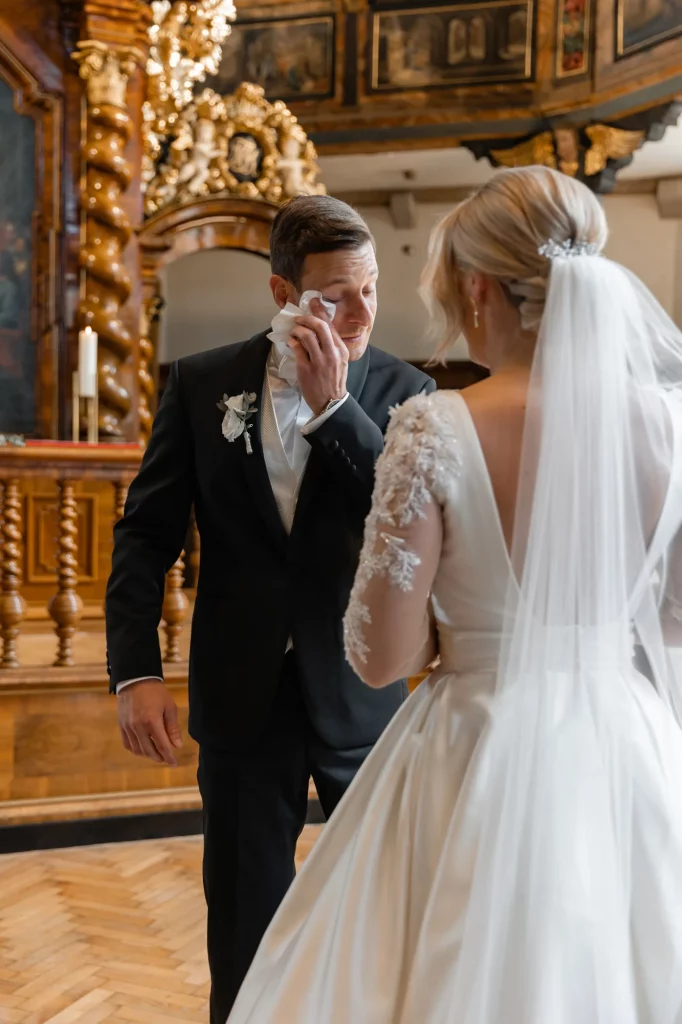 the groom cries with happiness in the church, and the bride stands facing him, zhe first meeting of the groom and the bride