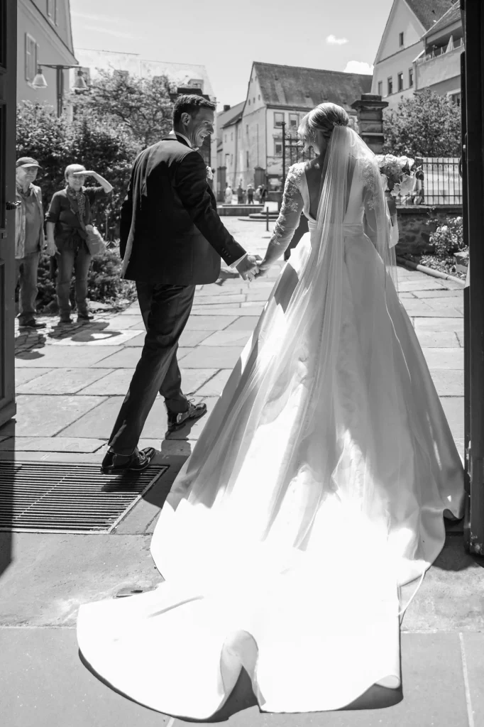 The bride and the groom leave the church smiling happily, wedding moment