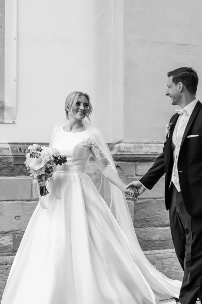 A wedding couple is Walking neer a beautiful castle