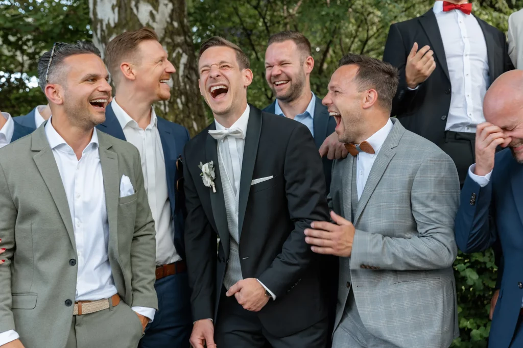 the groom with his friends smiling