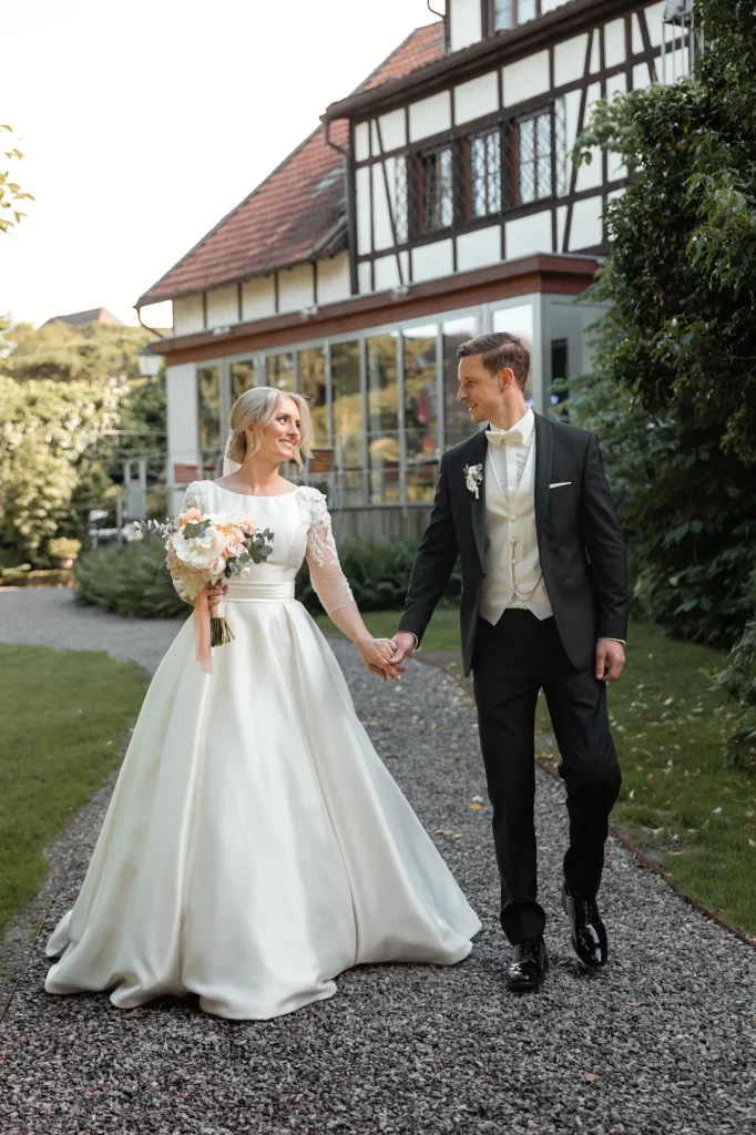 the wedding couple is walking on the wedding location