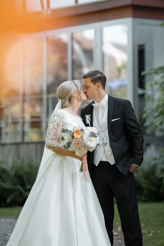 the wedding couple kisses