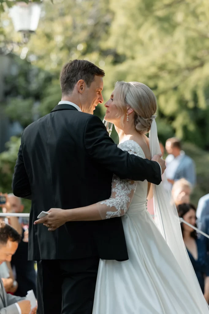 the bride and groom look at each other with love