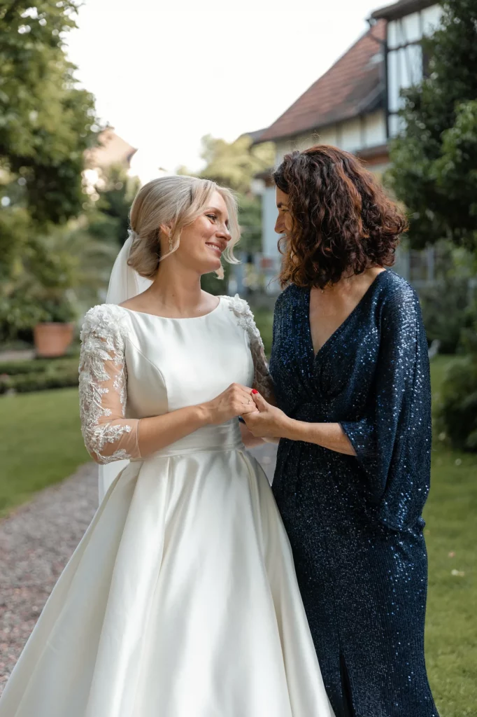 The bride stands with her mother