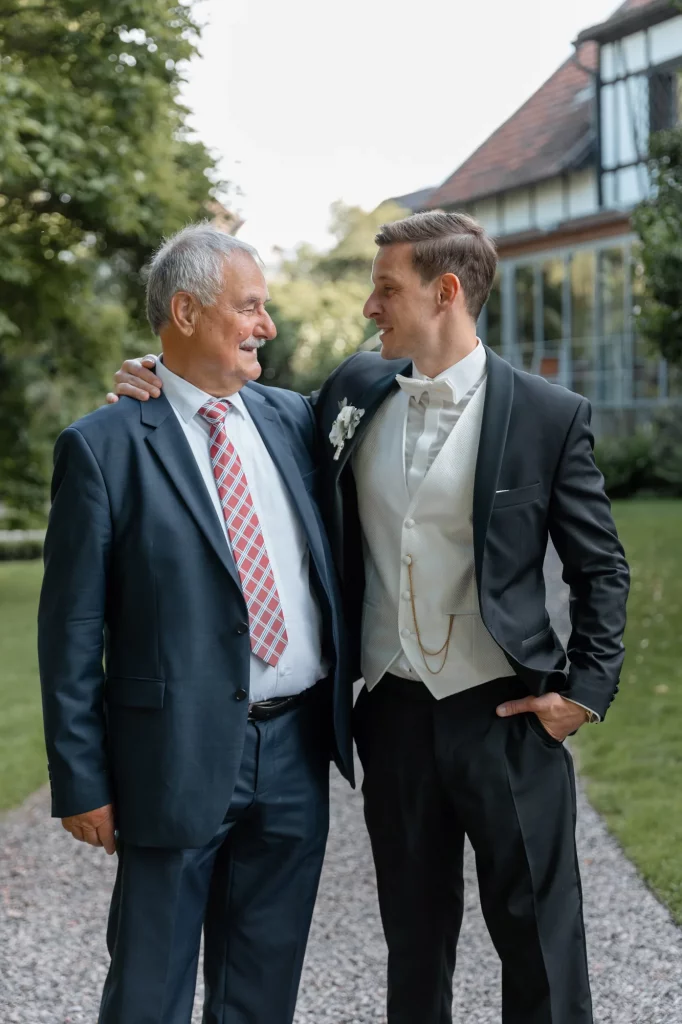 the groom hugs with his father