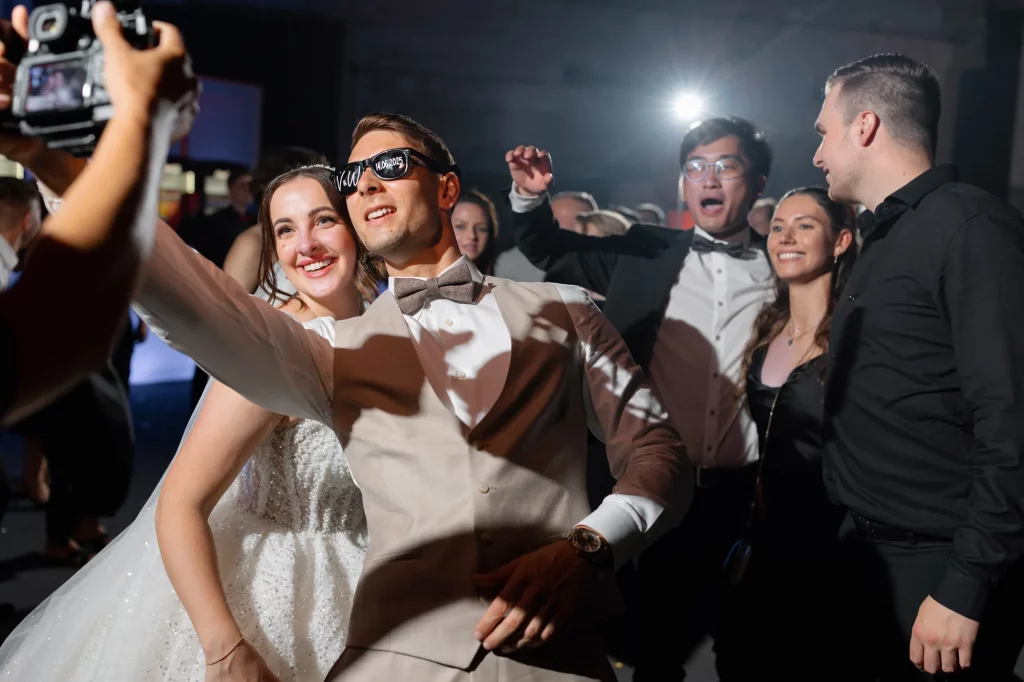 Brautpaar macht Selfie mit Freunden